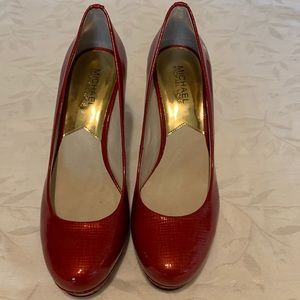 Michael Kors ruby red platform pumps.